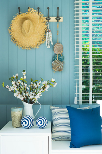 Coastal blue modern cushion and flower vase in modern living room