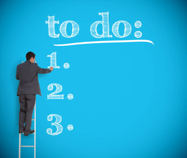 istock Businessman writing a to do list on a giant wall 847564240
