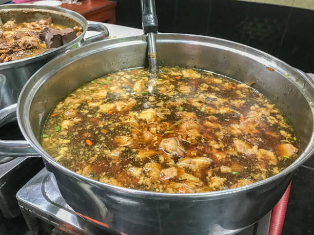 istock stewed pork noodle soup in big pot 847575564