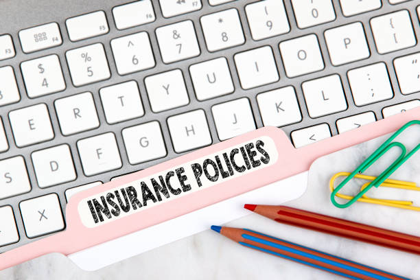 istock Insurance Policies concept. Folder Register on Background of Computer Keyboard 847580928