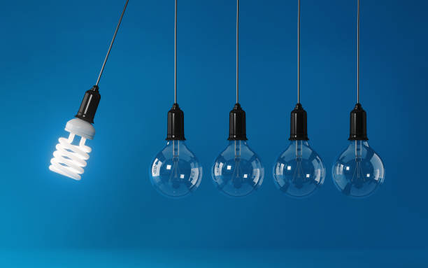 istock Energy Saving Light Bulb In Perpetual Motion on Blue Background: Energy Efficiency Concept 847583710