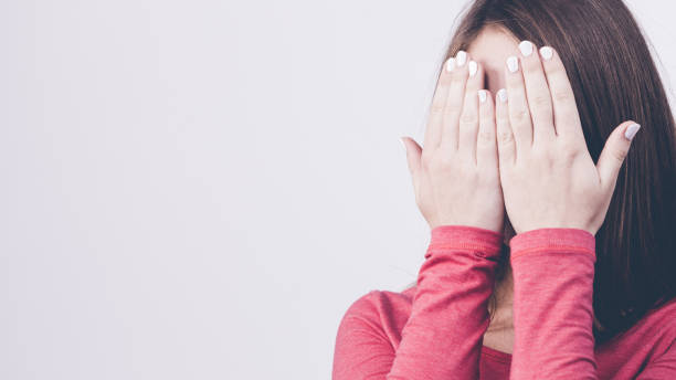 istock Shy girl hides her face 847584676