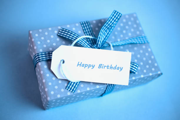 istock Pretty blue gift with a happy birthday card on a blue background 847590166