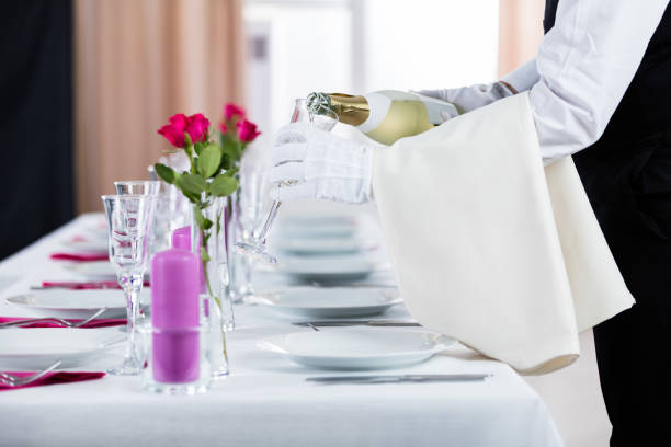 Close-up Of Waiter Pouring Champagne Into Glass