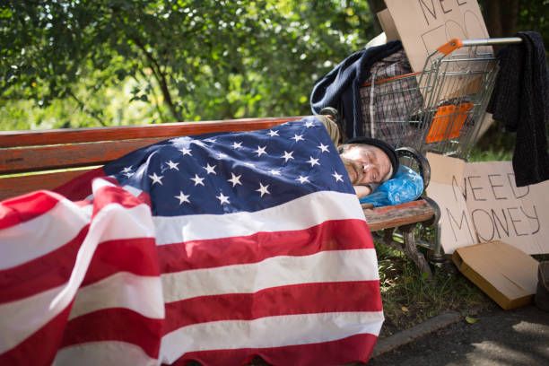istock Homeless man using USA flag as a blanket. 847594438