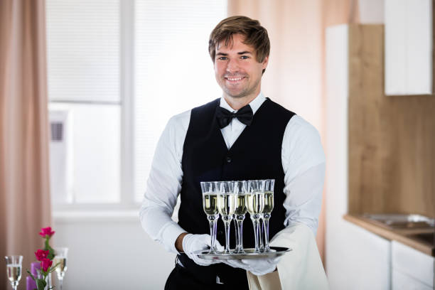 Waiter in red uniform  drops a tray with glass