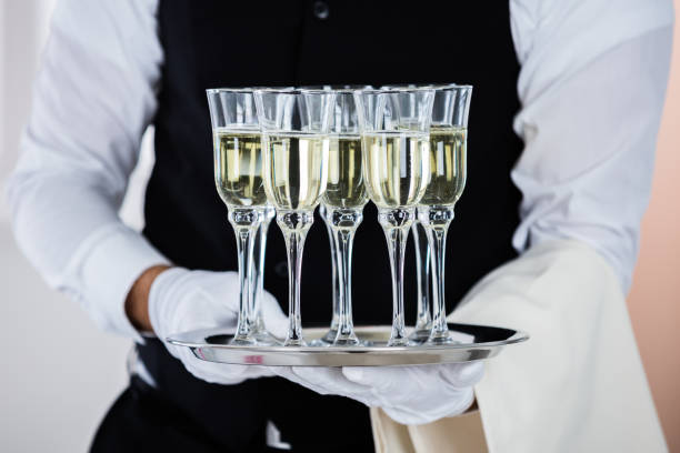 istock Man Holding Champagne Glasses 847596838