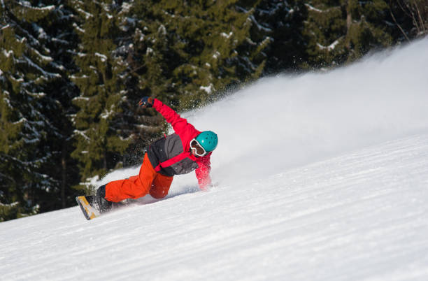istock Professional freerider snowboarding in the winther mountains. Forest on the background. snowboarder freeride 847598154
