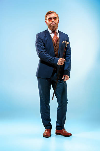 istock The barded man in a suit holding cane 847601054