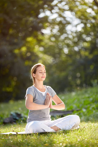 istock Female in nature practicing yoga 847607042