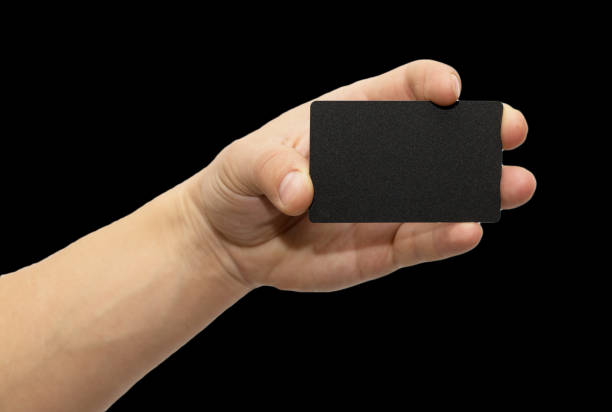 istock black card in hand on a black background 847607130