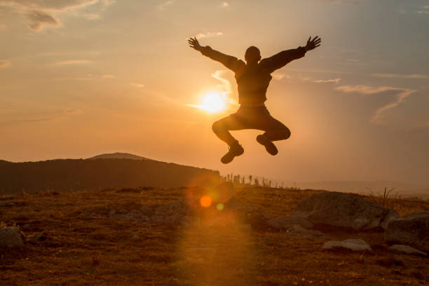 istock Silhouette of happy people jumping 847616976