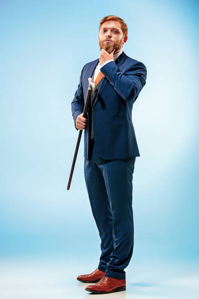istock The barded man in a suit holding cane 847618218