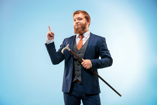 istock The barded man in a suit holding cane 847618416