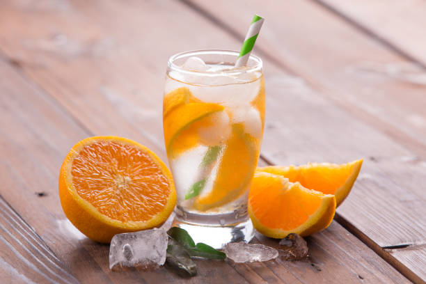 istock Orange cocktail on brown wooden background 847620546