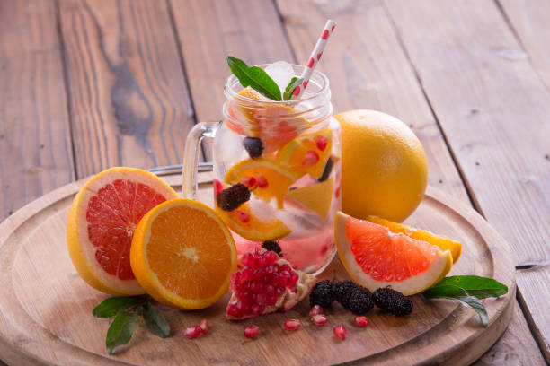 istock Refreshing sangria / punch with orange, pomegranate seeds, blackberry, and grapefruit on brown rustic wooden background 847622124