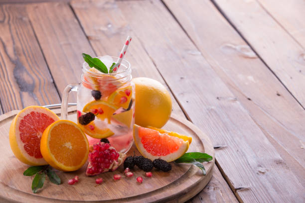 istock Refreshing sangria / punch with orange, pomegranate seeds, blackberry, and grapefruit on brown rustic wooden background 847622286