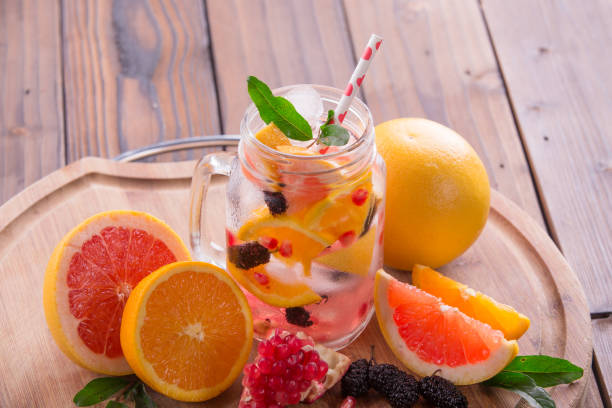 istock Refreshing sangria / punch with orange, pomegranate seeds, blackberry, and grapefruit on brown rustic wooden background 847622624