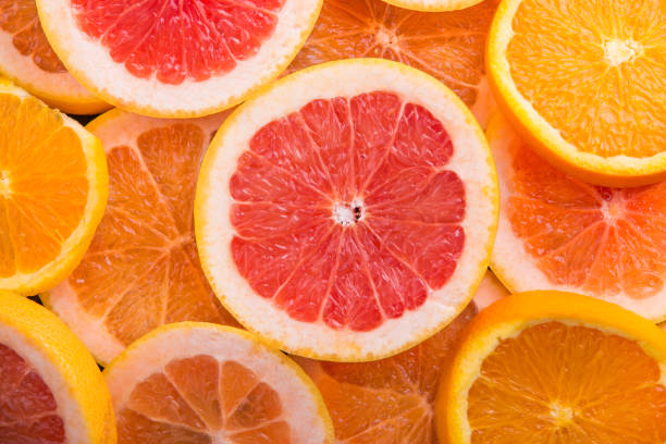 istock Slice citrus: orange, mandarin and grapefruit on brown wooden background 847623062