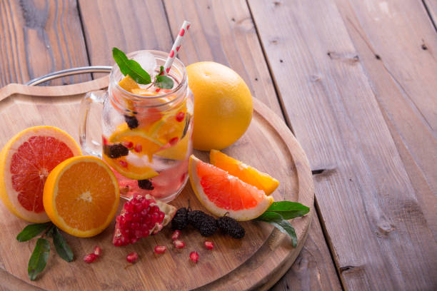 istock Refreshing sangria / punch with orange, pomegranate seeds, blackberry, and grapefruit on brown rustic wooden background 847623080