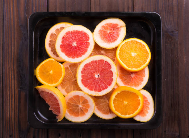 istock Slice citrus: orange, mandarin and grapefruit on brown wooden background 847623358