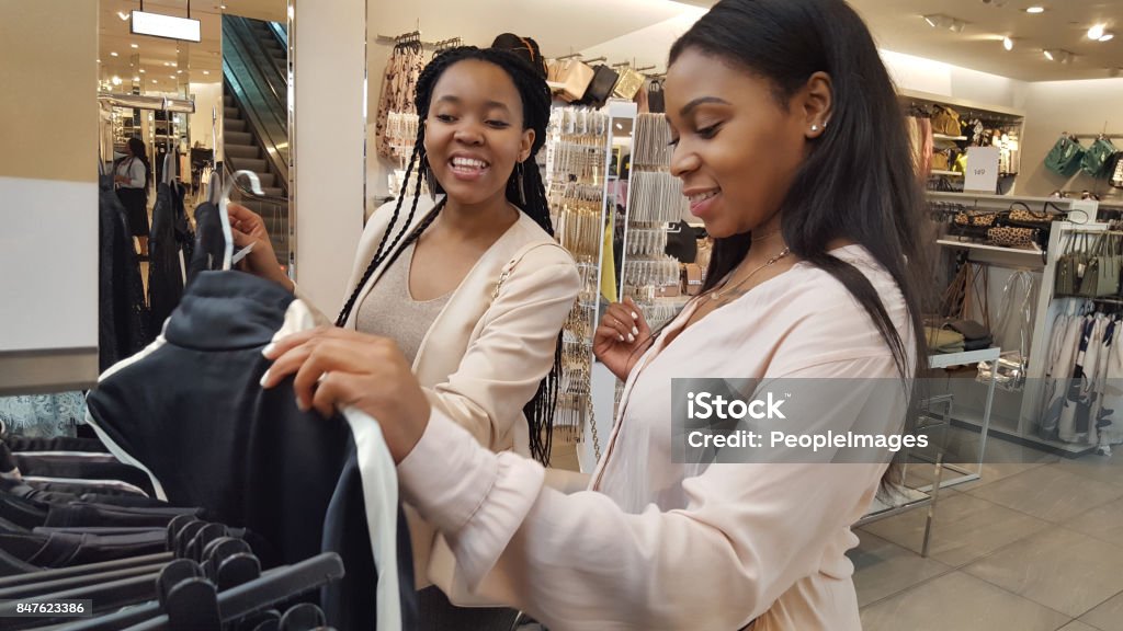 Friends forever in fashion Shot of two young women shopping for clothes in a boutique 20-29 Years Stock Photo