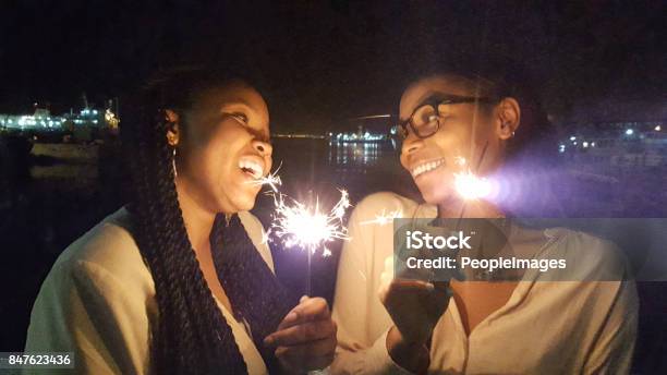 Best Friends Add Sparkle To Your Life Stock Photo - Download Image Now - African Ethnicity, Sparkler - Firework, Young Women