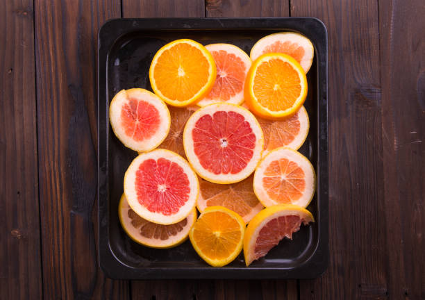 istock Slice citrus: orange, mandarin and grapefruit on brown wooden background 847623644