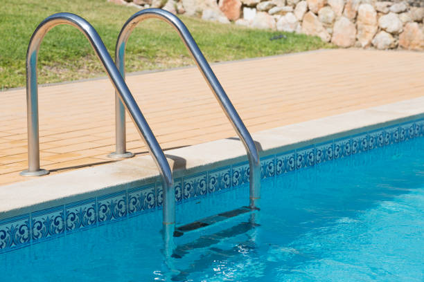 istock Stainless steel steps leading into swimming pool 847632320