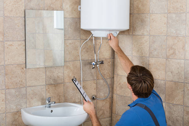 istock Male Plumber Holding Clipboard Checking Electric Boiler 847632768