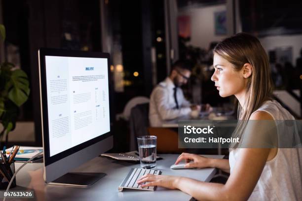 Businesswoman In Her Office At Night Working Late Stock Photo - Download Image Now - Working Late, Working, Night