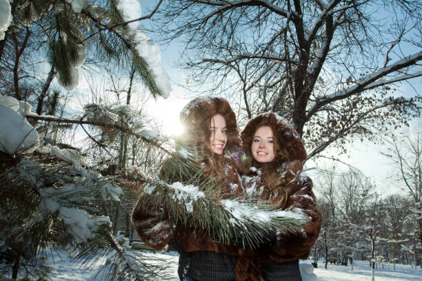 Twin sisters playing snowballs