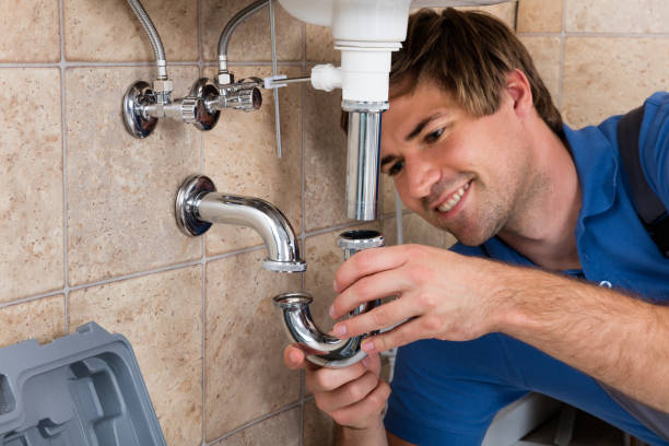 Plumber Fitting Sink Pipe Young Male Plumber Fitting Sink Pipe In Bathroom bathroom sink photos stock pictures, royalty-free photos & images