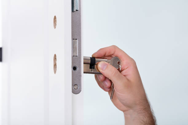 istock Man's Hand Installing Door Lock In Door 847637570
