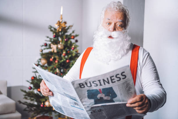 istock santa claus reading newspaper 847640358