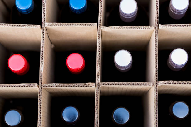 Wine bottles of red and white wine in cardboard box Wine bottles of red and white wine in cardboard box view from top focus on colourful caps. Full frame macro crop backgrounds. Horizontal orientation wine shipping stock pictures, royalty-free photos & images