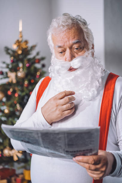 istock santa claus reading newspaper 847645646