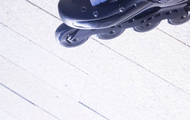 istock Inline freestyle roller blade skates in street on road surface skating. 847647944