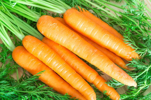 istock Fresh and sweet carrots on wooden table. 847648598