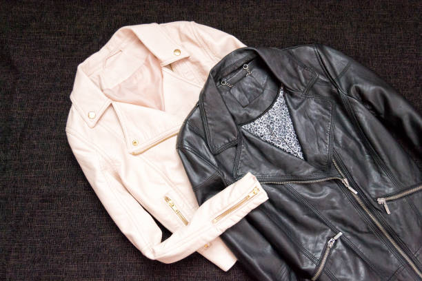 istock Fashionable concept. Two leather jackets on a black background. Top view, space for text 847655198
