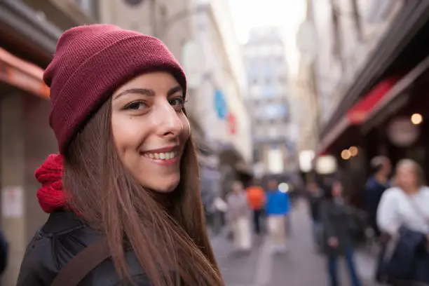 Close up of an attractive young woman enjoying exploring the laneways of downtown Melbourne.