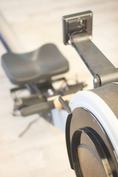 istock Gym exercise rowing machine static rower in gymnasium fitness studio. 847670580