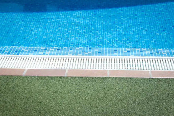 Outdoor swimming pool water on hot summerday in luxury hotel.