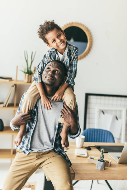 istock beautiful son piggybacking on father 847674298