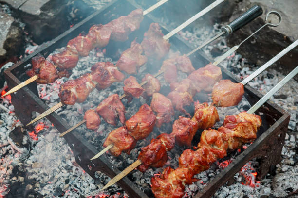 istock Meat on skewers roasting over bbq grill 847674346