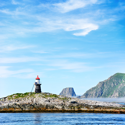Lighthouse on Gjesværstappan islands in Nordkapp Municipality of Norway. Composite photo