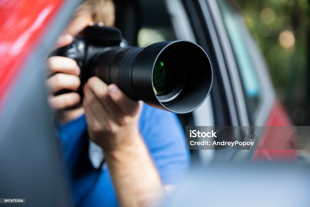 Man Photographing With SLR Camera Private Detective Sitting Inside Car Photographing With SLR Camera Detective Stock Photo