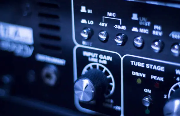 Professional sound recording audio studio digital equipment, amplifier, knobs and graphic equalizer controls.