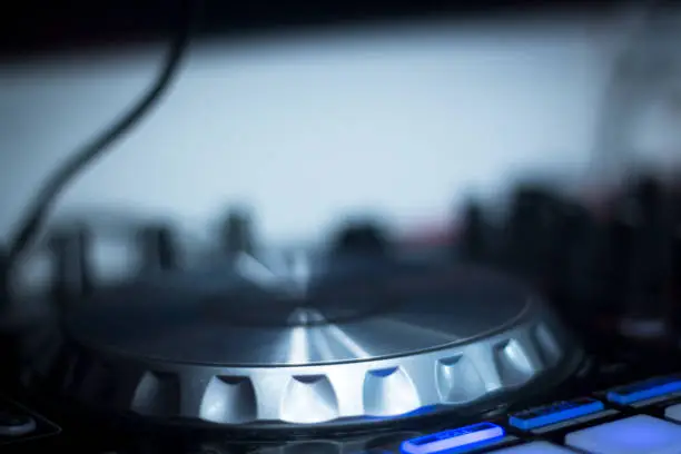 Ibiza dj turntables for deejay mixing in nightclub house music party at night during techno show.