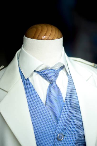 istock Catholic first communion religious ceremony uniform white suit blue shirt and tie for boys on sale in store. 847675864